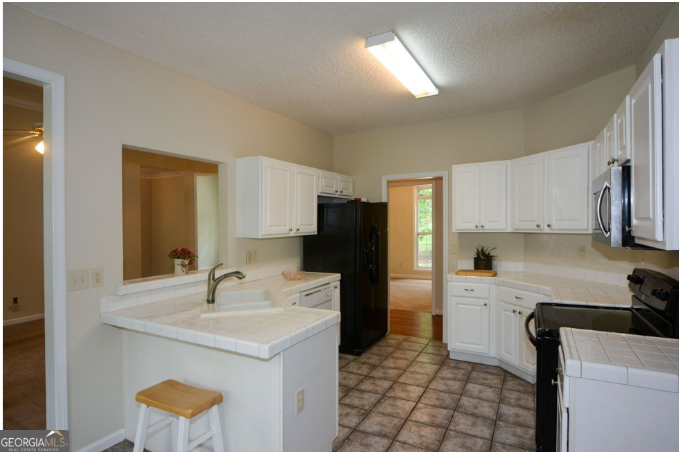 102 Buell Jones Road Carrollton, GA 30117 - Photo 15 of 27 a kitchen with a sink cabinets and appliances