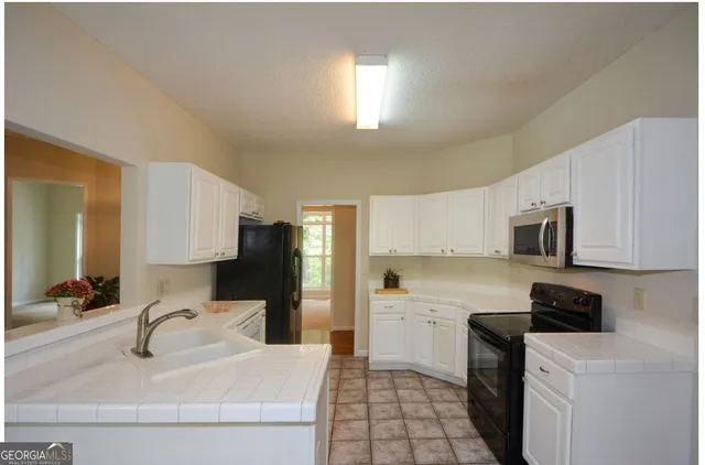 a kitchen with a sink a stove and refrigerator