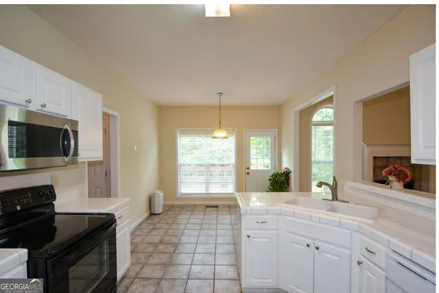 a spacious bathroom with a double vanity sink a mirror and a bathtub