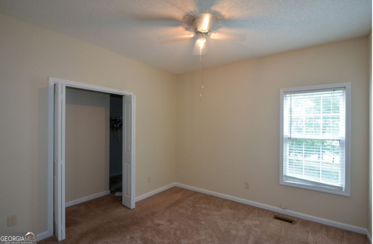 102 Buell Jones Road Carrollton, GA 30117 - Photo 19 of 27 an empty room with windows and fan