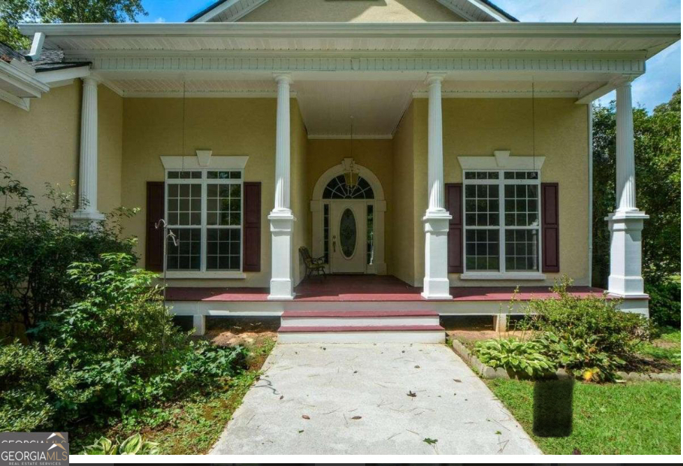 102 Buell Jones Road Carrollton, GA 30117 - Photo 2 of 27 a view of a brick house with potted plants