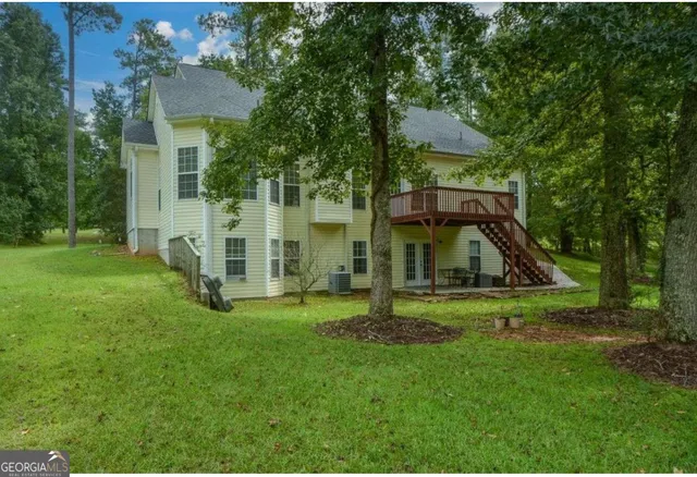 a view of a backyard with a garden and entertaining space