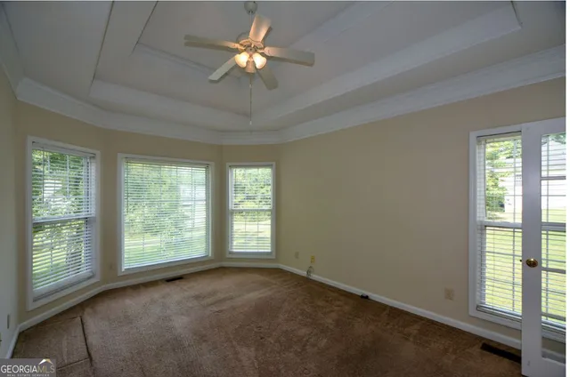 a view of a livingroom with a ceiling fan and window