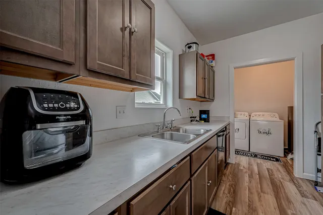 a kitchen with stainless steel appliances a stove a sink and a refrigerator