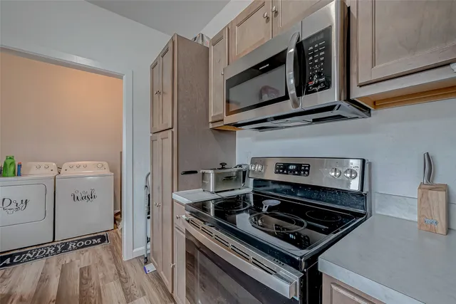 a kitchen with a stove and a microwave