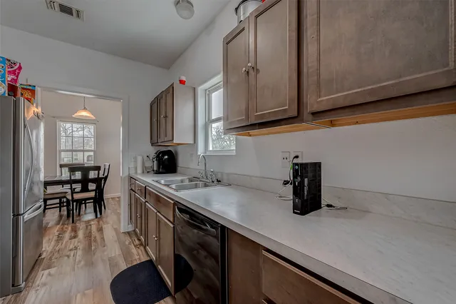 a kitchen with stainless steel appliances granite countertop a sink and cabinets