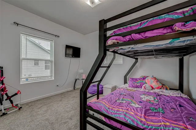 a bedroom with a bed and window