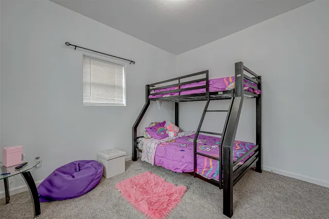 a bedroom with a bed and a bedroom