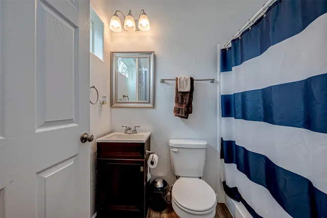 a white toilet sitting next to a bathroom sink