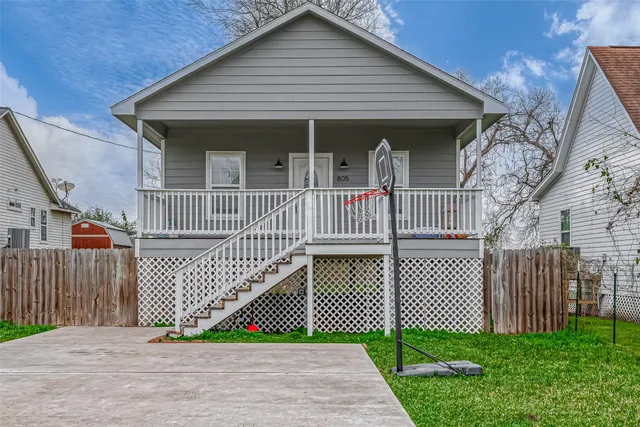 a front view of a house with iron fence