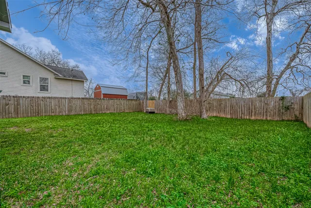 a view of a backyard with large trees