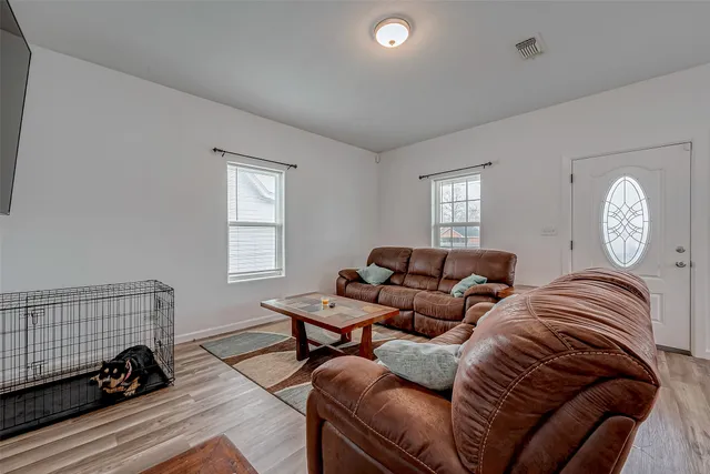 a living room with furniture a bed and a window