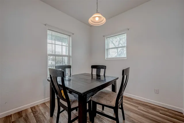 a view of a dining room with a table and chairs