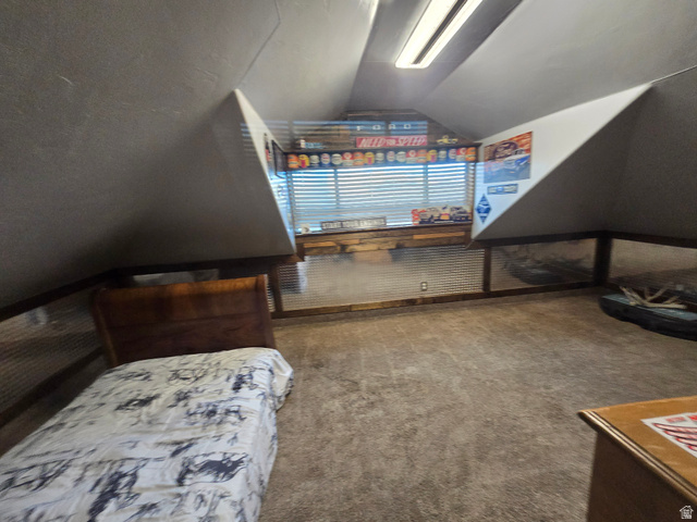 34200 Coulam Road Swan Lake, ID 83281 - Photo 13 of 24 Attic space featuring sloped ceilings, recessed window with horizontal blinds, wood-finish trim, and corrugated metal wall paneling