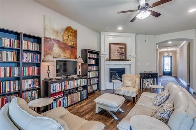a living room with furniture and a book shelf