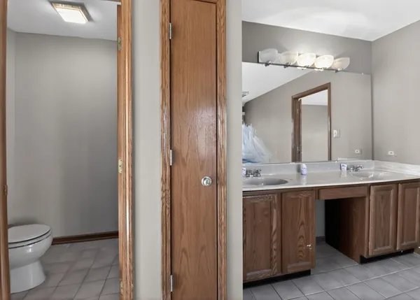 a bathroom with a double vanity sink and mirror