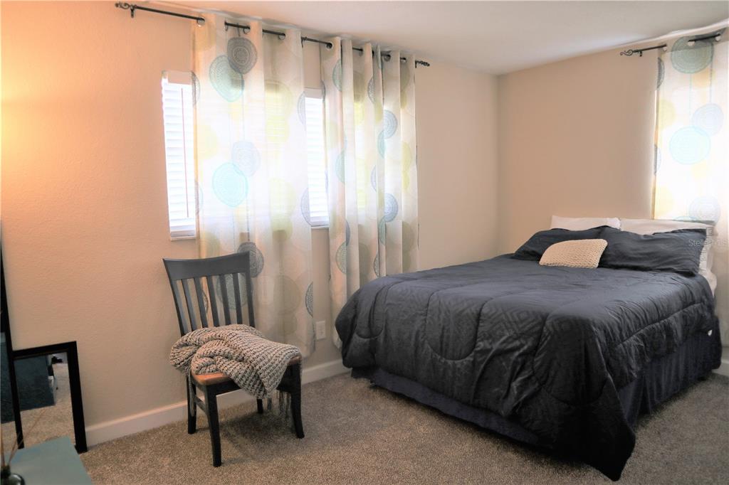 1468 South Evergreen Avenue Clearwater, FL 33756 - Photo 12 of 23 a bedroom with a bed chair and window
