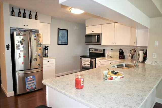 a kitchen with a refrigerator a stove a microwave and a counter space