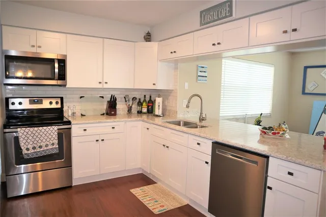 a kitchen with a sink stove and microwave