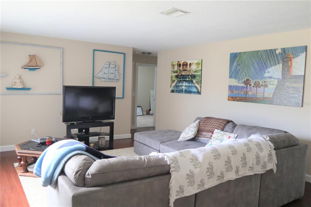 1468 South Evergreen Avenue Clearwater, FL 33756 - Photo 2 of 23 a bedroom with furniture and a flat screen tv
