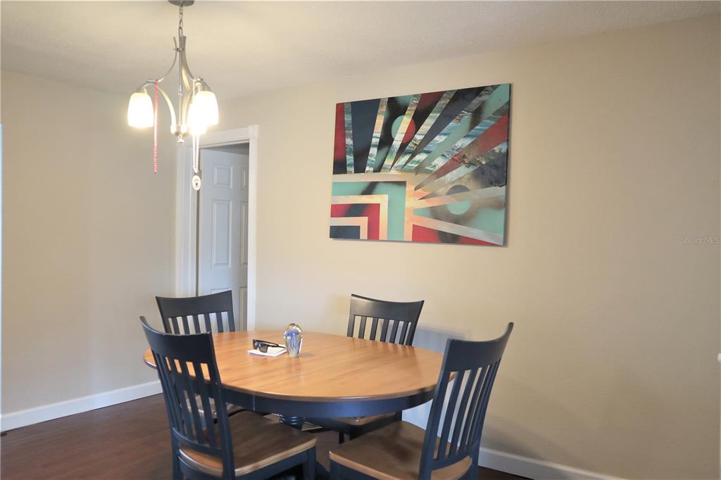 1468 South Evergreen Avenue Clearwater, FL 33756 - Photo 4 of 23 a view of a dining room with furniture and wooden floor