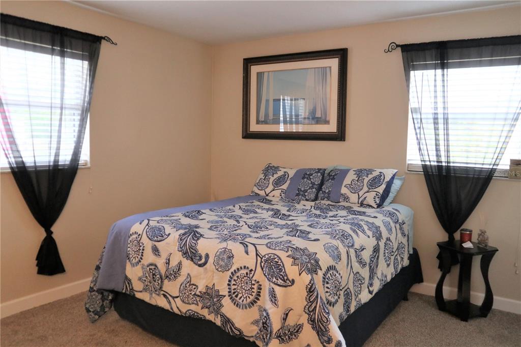 1468 South Evergreen Avenue Clearwater, FL 33756 - Photo 6 of 23 a bedroom with a bed and wooden floor