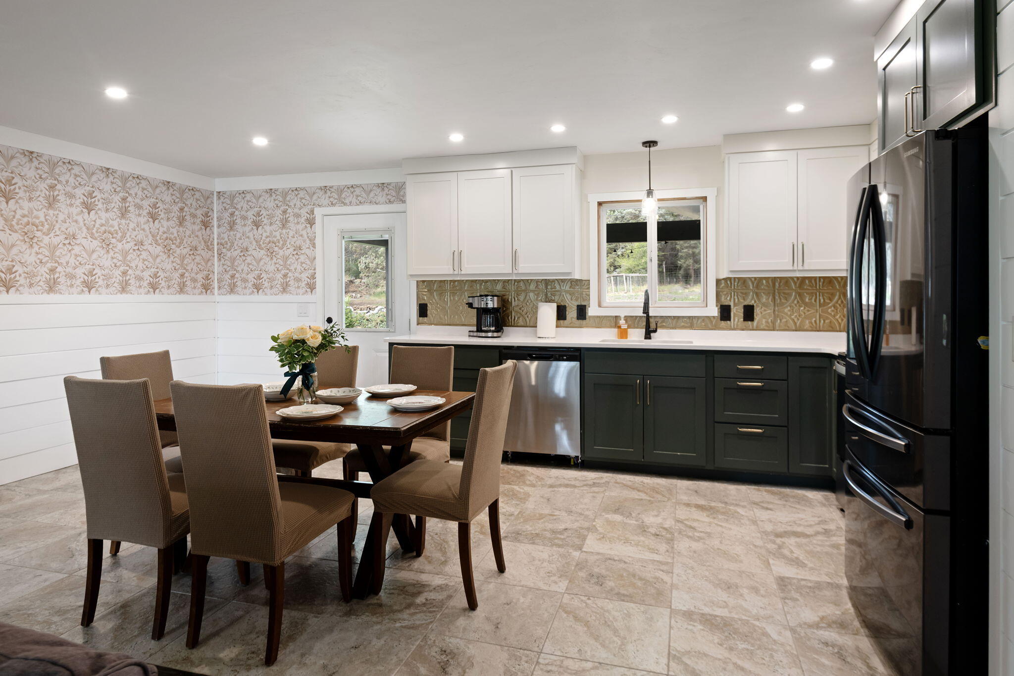 1971 Southwest 25th Street Redmond, OR 97756 - Photo 11 of 30 a kitchen with stainless steel appliances granite countertop a sink a stove a dining table and chairs