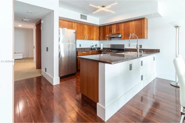a kitchen with stainless steel appliances granite countertop a sink stove and refrigerator