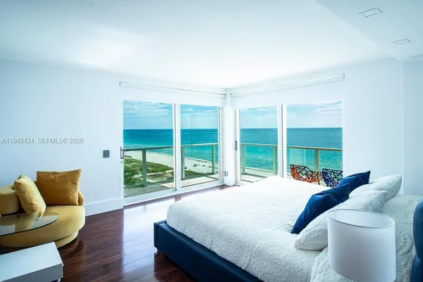 a bed sitting in a bedroom next to a large window