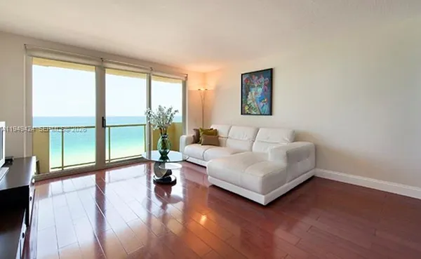 a living room with couch and a large window