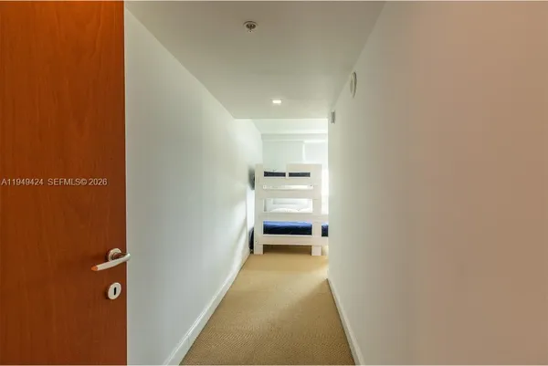 a view of a hallway with a bedroom