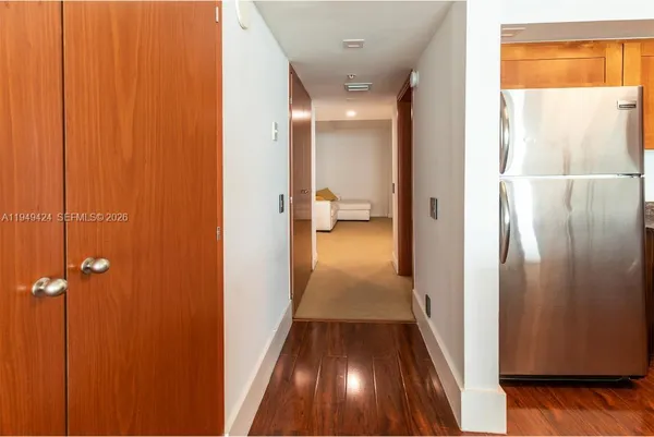 a view of a hallway with wooden floor