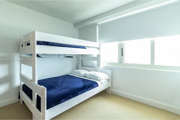 a bedroom with a bed and a cabinet