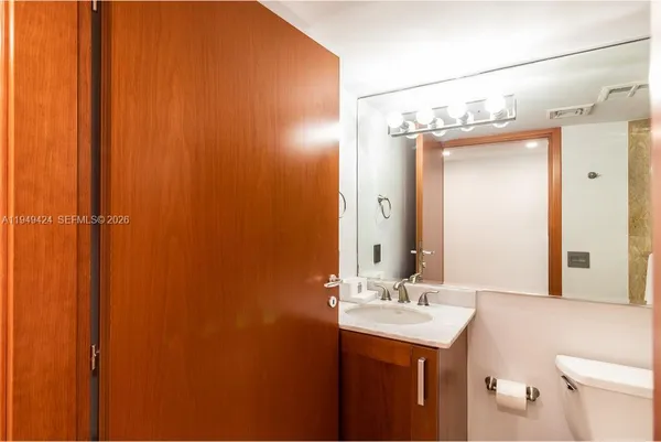 a bathroom that has a glass shower door