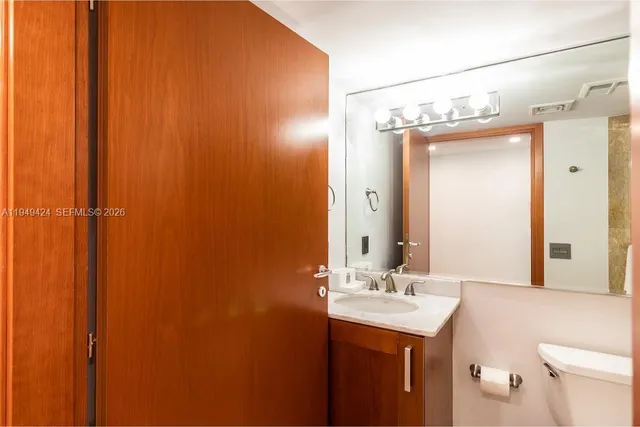 a bathroom that has a glass shower door