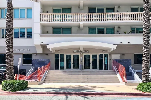a view of a tall building with a yard