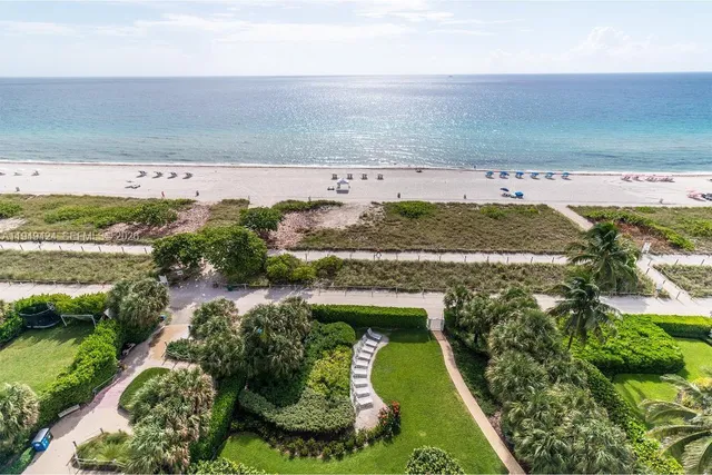 an aerial view of beach and residential houses with outdoor space