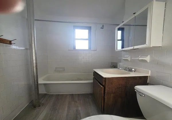 a bathroom with a sink a toilet and bathtub