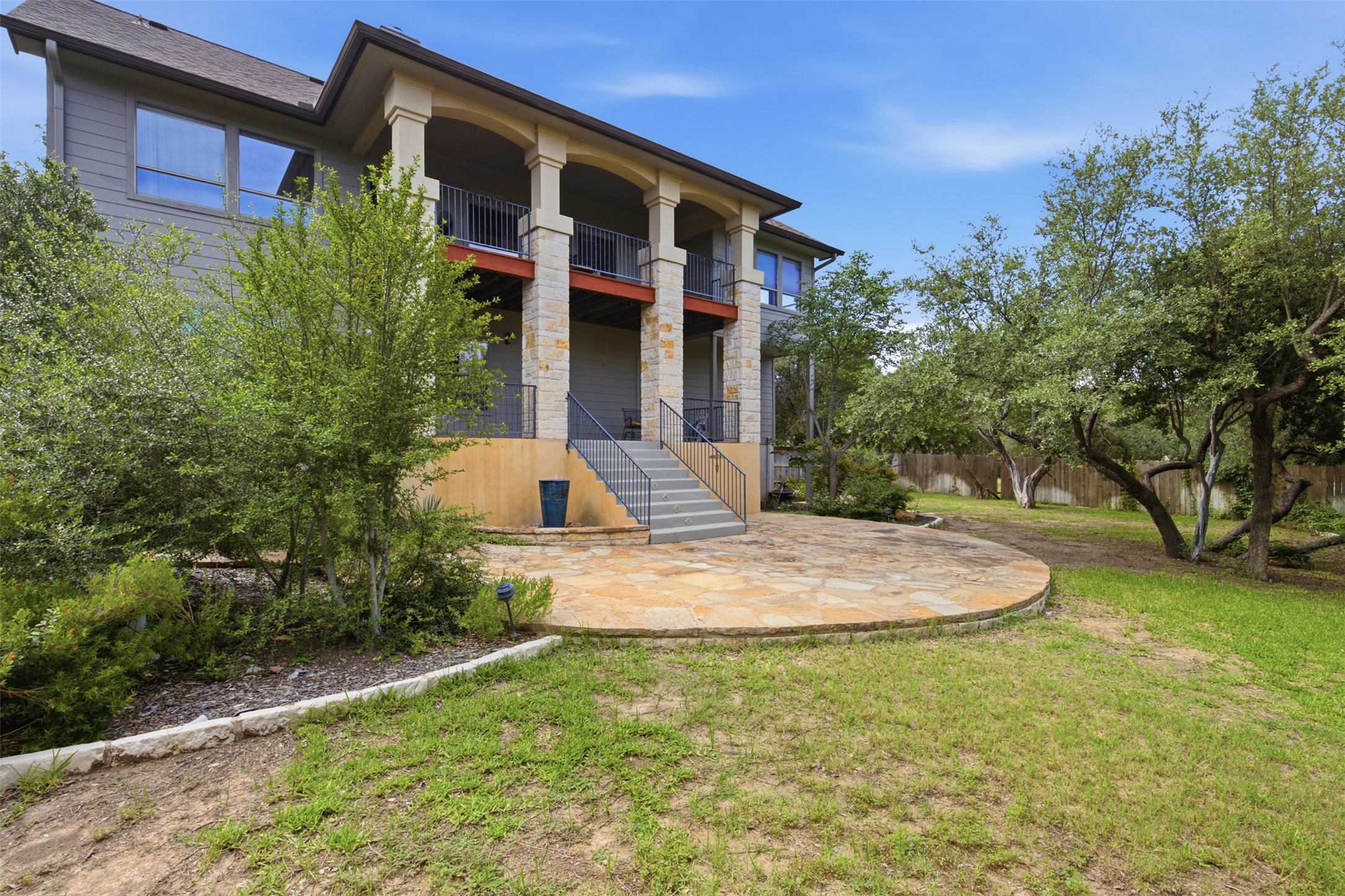 700 Augusta Circle Point Venture, TX 78645 - Photo 24 of 35 A private backyard oasis with an elevated balcony and spacious stone patio awaits.