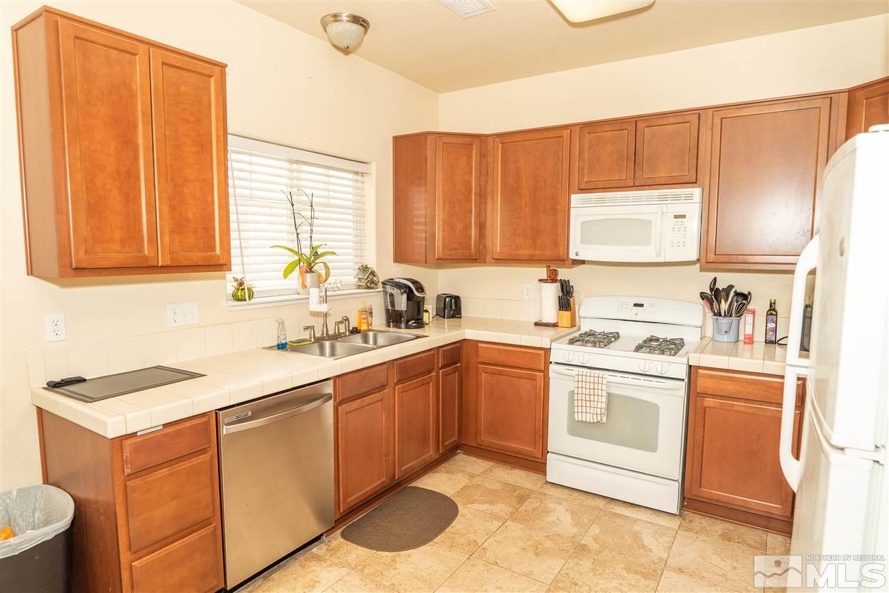 4805 Ciarra Kennedy Lane Reno, NV 89503 - Photo 3 of 16 a kitchen with stainless steel appliances granite countertop a sink stove and refrigerator