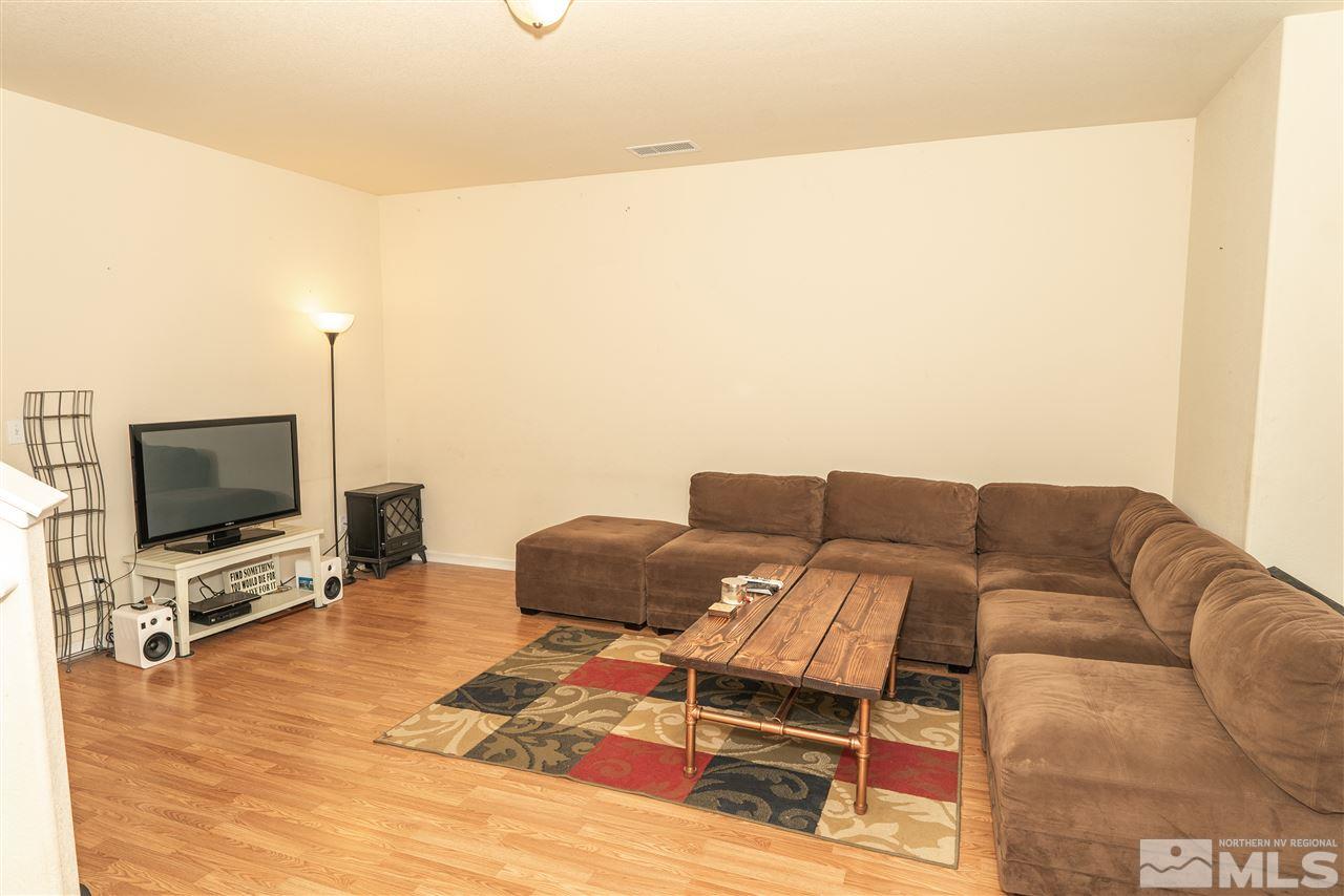 4805 Ciarra Kennedy Lane Reno, NV 89503 - Photo 5 of 16 a living room with furniture and a flat screen tv