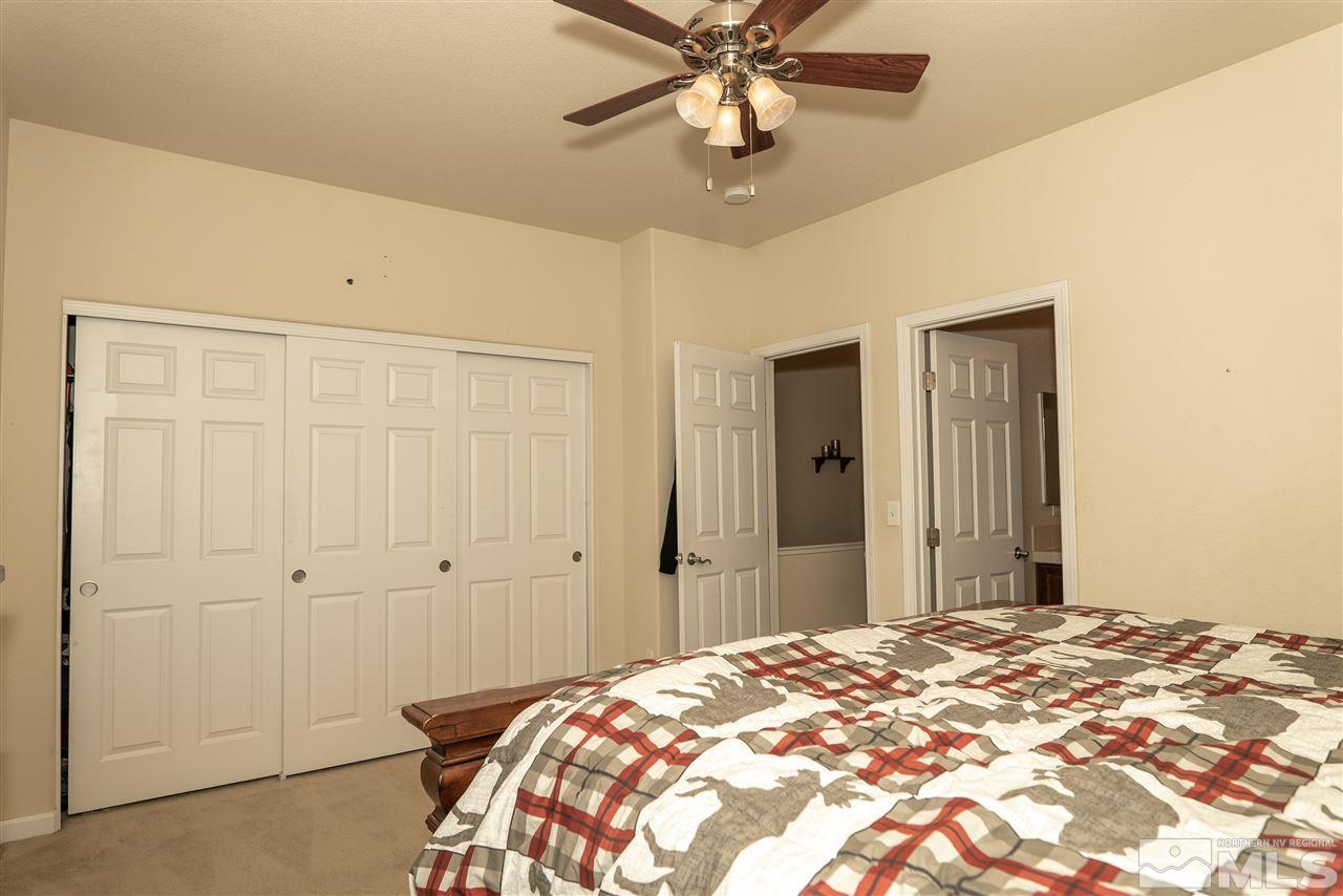 4805 Ciarra Kennedy Lane Reno, NV 89503 - Photo 10 of 16 a bedroom with a bed and a chandelier