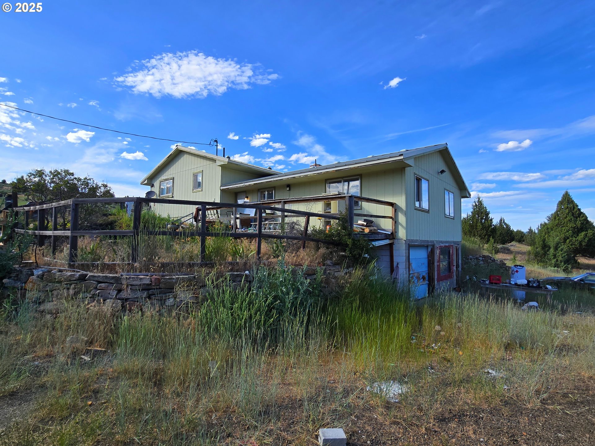 26113 West Bench Road John Day, OR 97845 - Photo 9 of 17 a view of a lake with a house in the background
