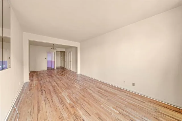 a view of a room with wooden floor and white walls