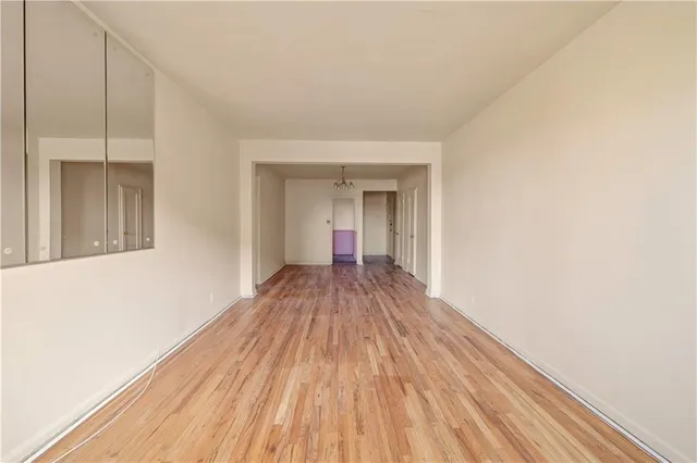 a view of a room with wooden floor