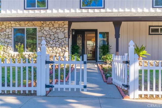 a house with potted plants in front of door