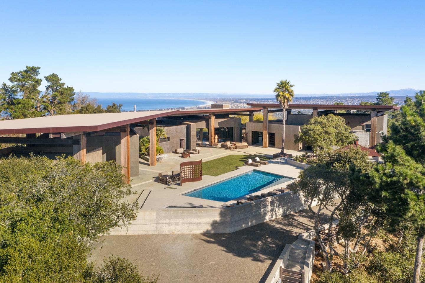 566 Aguajito Road Carmel, CA 93923 - Photo 2 of 78 a view of a swimming pool with an outdoor seating and a garden