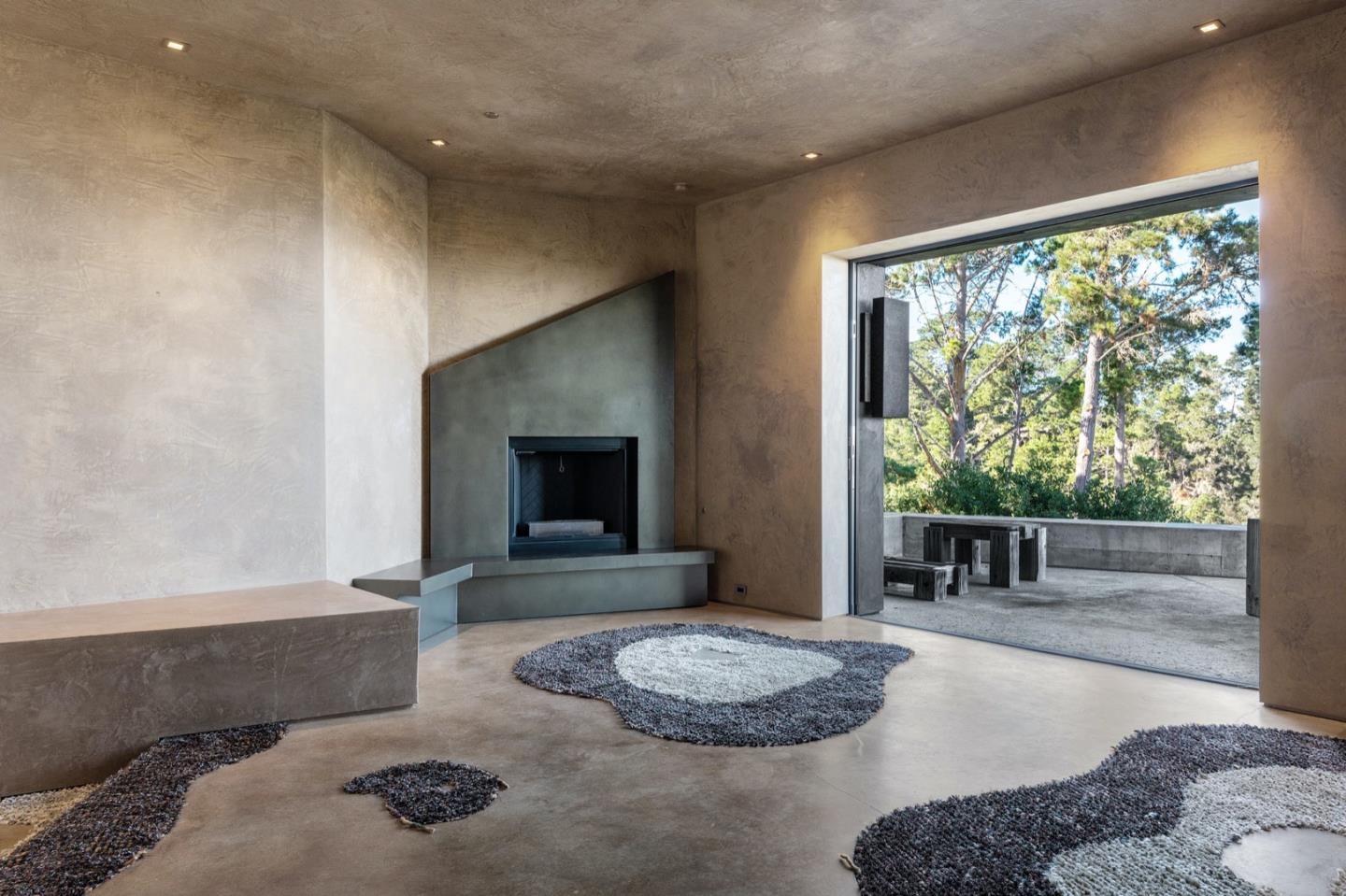 566 Aguajito Road Carmel, CA 93923 - Photo 29 of 78 a living room with furniture and a fireplace