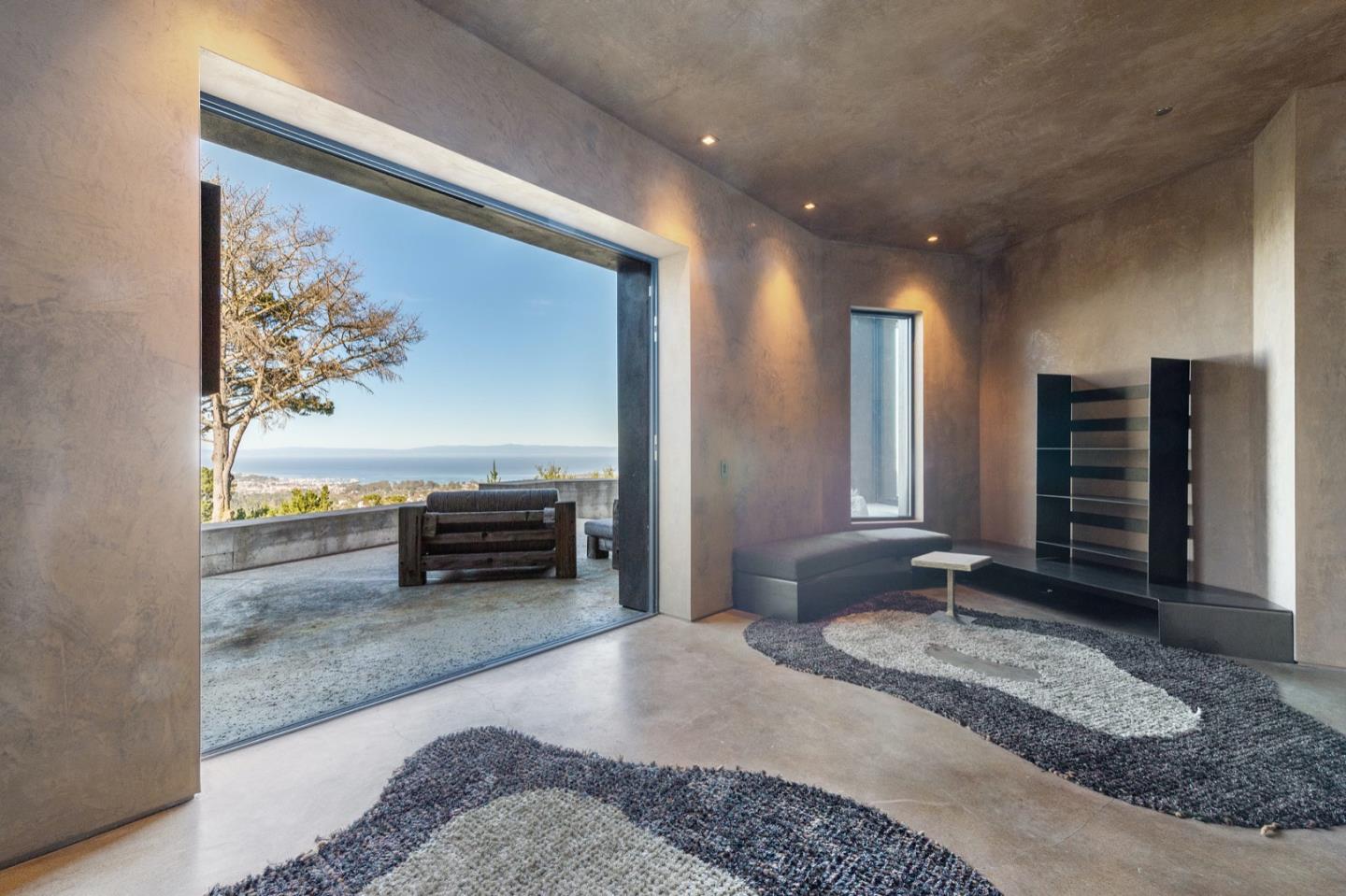 566 Aguajito Road Carmel, CA 93923 - Photo 30 of 78 a spacious bedroom with a bed and a couch