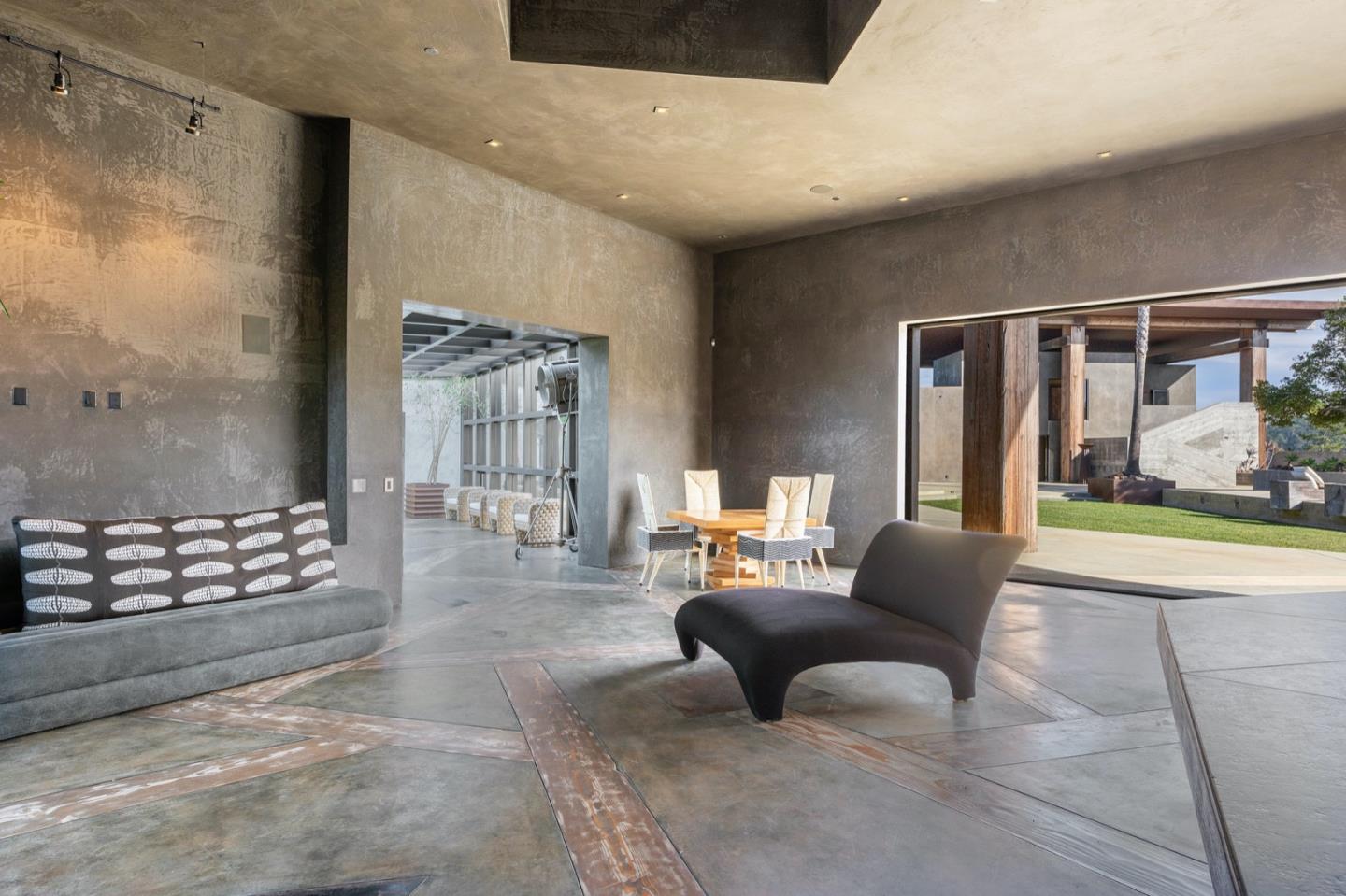 566 Aguajito Road Carmel, CA 93923 - Photo 43 of 78 a living room with furniture and a floor to ceiling window